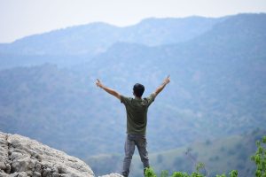 Man On Top Of Mountain Arms Out Stretched